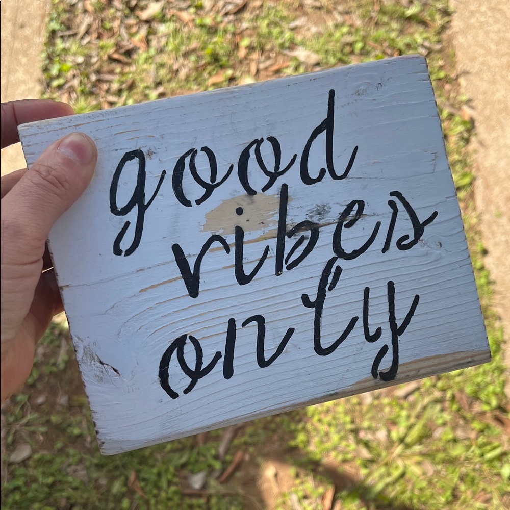 White Wooden Sign with Black Text